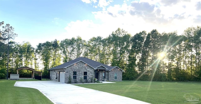 view of front of home with stone siding, an attached garage, a front lawn, and concrete driveway