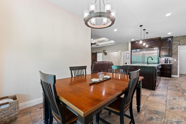 dining room featuring recessed lighting, stone finish floor, baseboards, and ceiling fan with notable chandelier