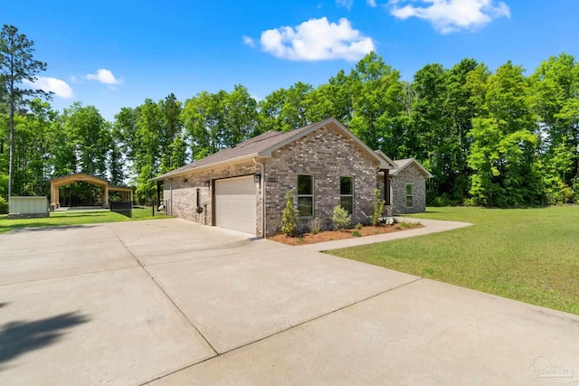 view of side of home with brick siding, a yard, driveway, and a garage