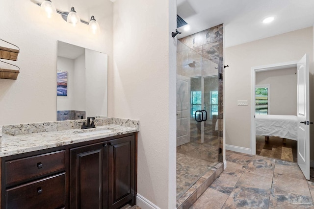 full bathroom featuring vanity, baseboards, connected bathroom, and a shower stall