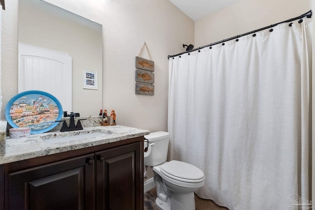 full bath featuring vanity and toilet