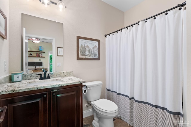 bathroom featuring toilet, vanity, a ceiling fan, and a shower with curtain
