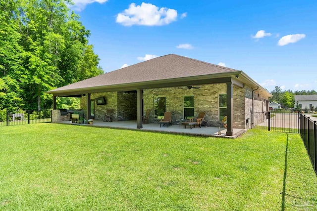 back of house with a lawn, a patio area, a fenced backyard, and a ceiling fan