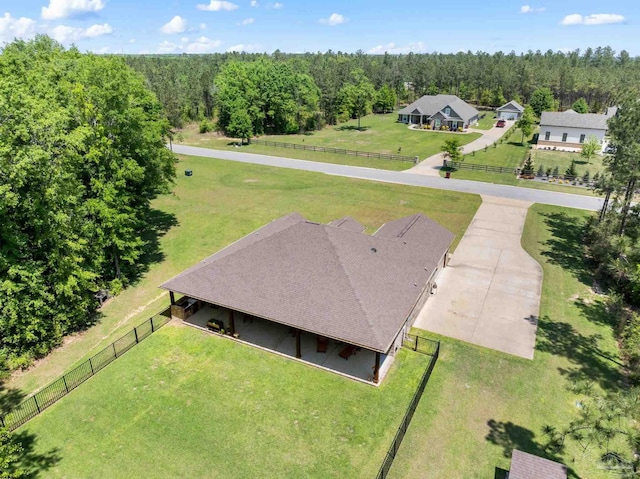 birds eye view of property with a forest view