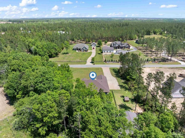 birds eye view of property with a view of trees