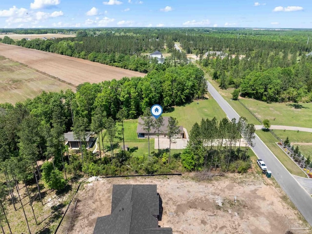 birds eye view of property featuring a view of trees