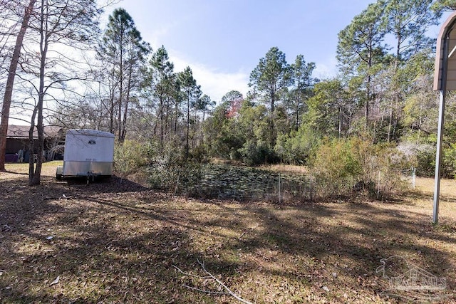 view of yard with a storage unit and an outbuilding