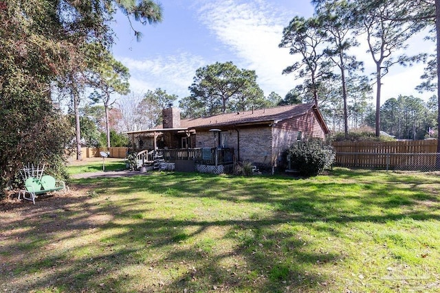 view of yard featuring a fenced backyard and a deck