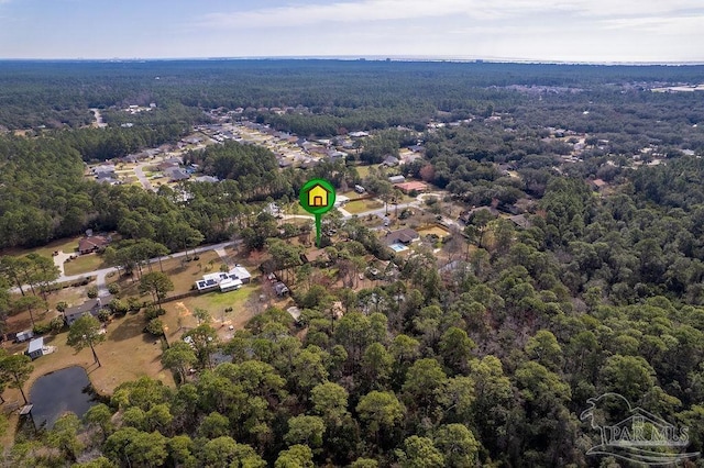 birds eye view of property featuring a water view and a wooded view