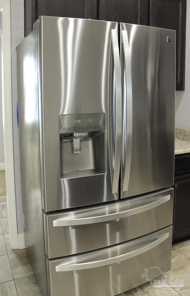 details with light stone counters and stainless steel fridge with ice dispenser