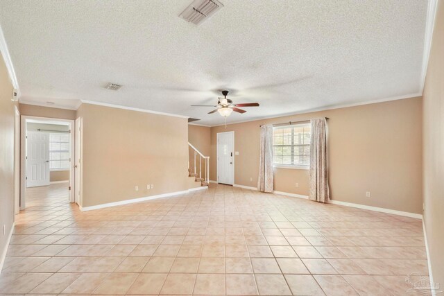 spare room featuring light tile patterned floors and a textured ceiling