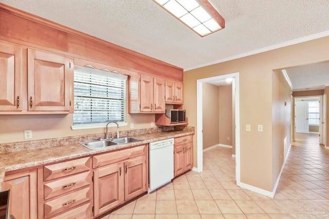 kitchen featuring a textured ceiling, sink, white dishwasher, and plenty of natural light