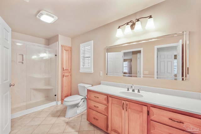 bathroom with toilet, vanity, tile patterned floors, and a shower with shower door