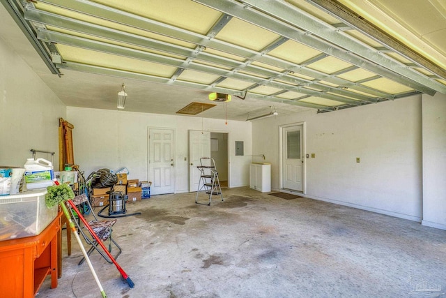 garage featuring electric panel and a garage door opener