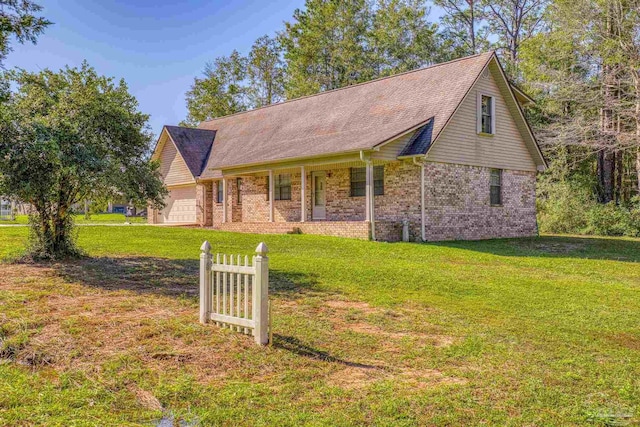 view of front of home with a front lawn, a porch, and a garage