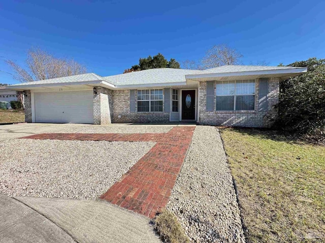 ranch-style home with a garage and a front lawn