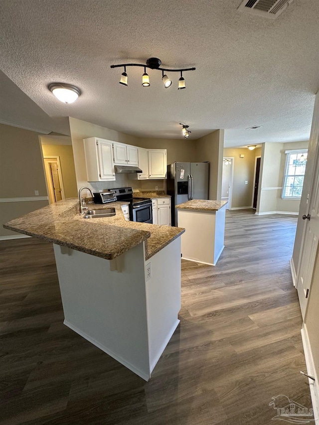 kitchen with white cabinetry, sink, stainless steel appliances, dark hardwood / wood-style flooring, and a kitchen island