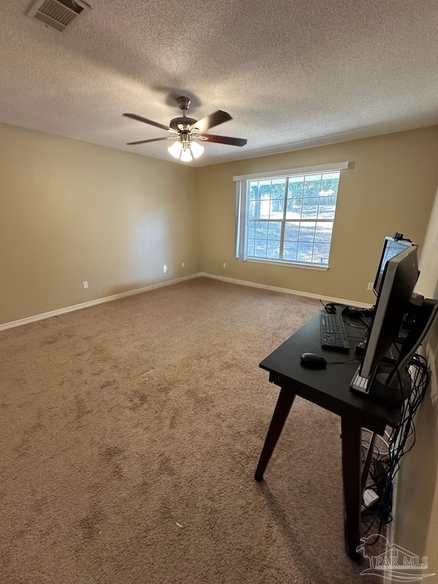 interior space with carpet flooring, a textured ceiling, and ceiling fan