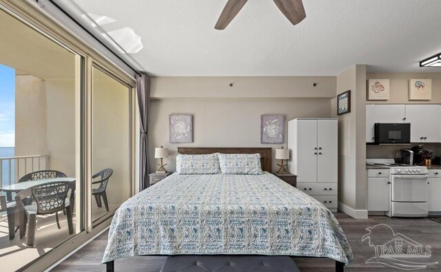 bedroom with ceiling fan, hardwood / wood-style flooring, and a textured ceiling