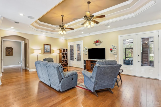 2882 Tunnel Rd, Pace, FL 32571 - living area featuring french doors, a tray ceiling, ornamental molding, ceiling fan, and light wood-style floors