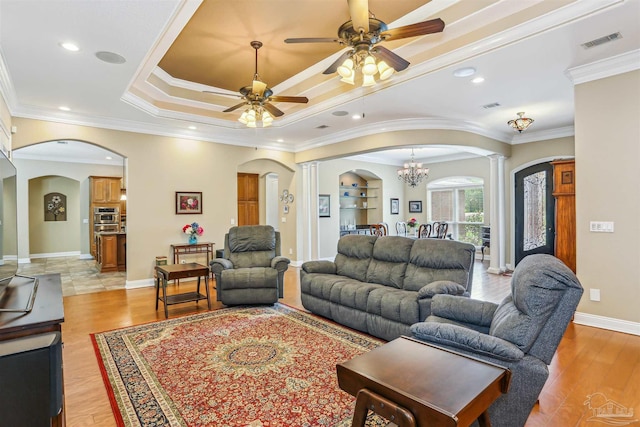 2882 Tunnel Rd, Pace, FL 32571 - living room featuring arched walkways, decorative columns, ceiling fan, light wood-style floors, and ornamental molding