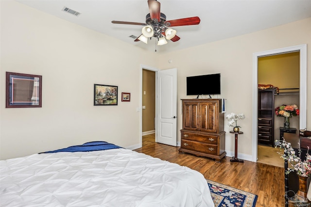 2882 Tunnel Rd, Pace, FL 32571 - bedroom featuring wood finished floors, a spacious closet, a closet, and a ceiling fan