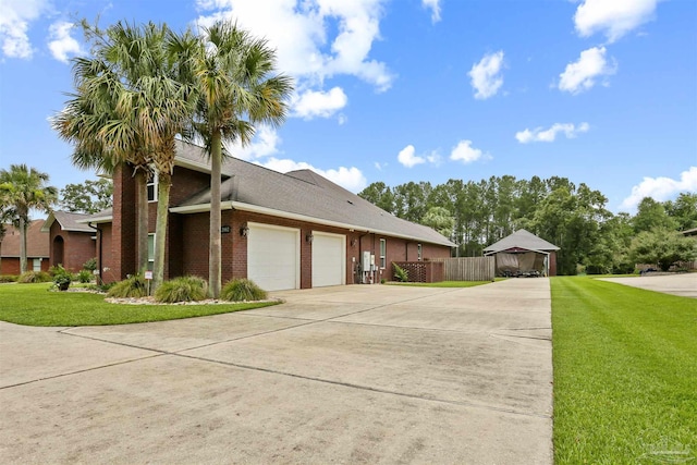 2882 Tunnel Rd, Pace, FL 32571 - view of property exterior featuring an attached garage, concrete driveway, and brick siding
