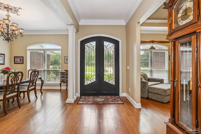 2882 Tunnel Rd, Pace, FL 32571 - entryway featuring arched walkways, ornamental molding, wood finished floors, french doors, and a chandelier