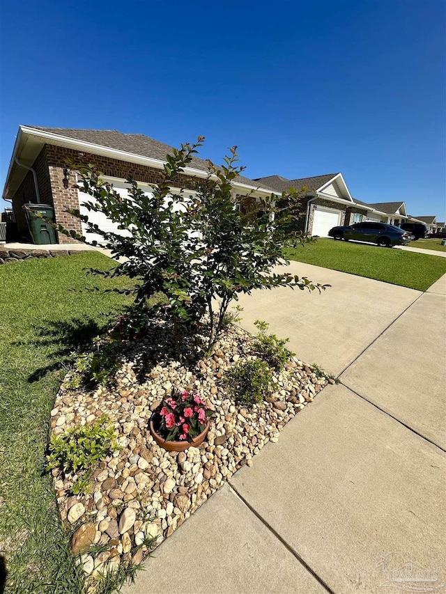 2656 Avalon St, Cantonment, FL 32533 - view of property exterior with a lawn, brick siding, an attached garage, and driveway