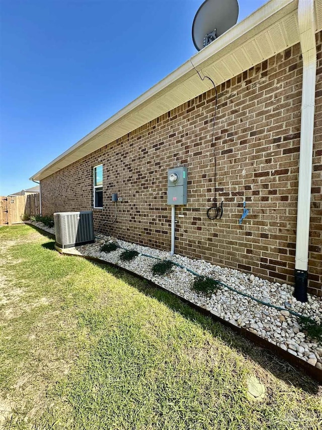 2656 Avalon St, Cantonment, FL 32533 - view of property exterior featuring a yard, brick siding, fence, and central AC unit