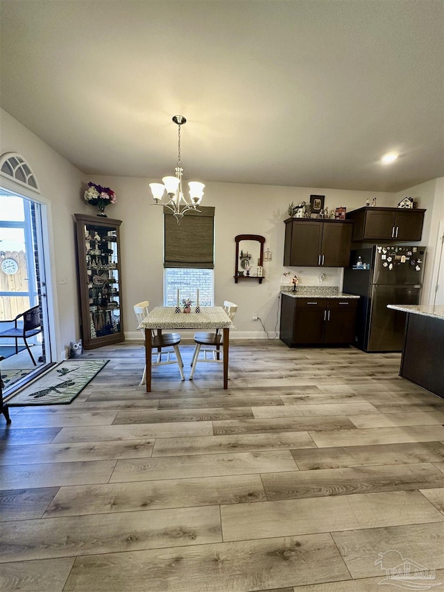 2656 Avalon St, Cantonment, FL 32533 - dining area with an inviting chandelier, baseboards, and light wood finished floors