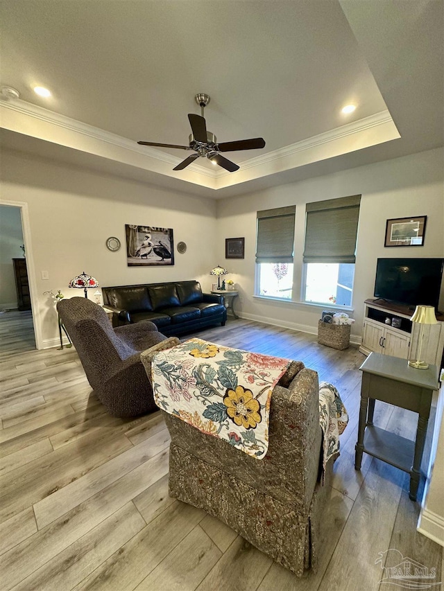 2656 Avalon St, Cantonment, FL 32533 - living area with a ceiling fan, baseboards, a tray ceiling, ornamental molding, and hardwood / wood-style flooring