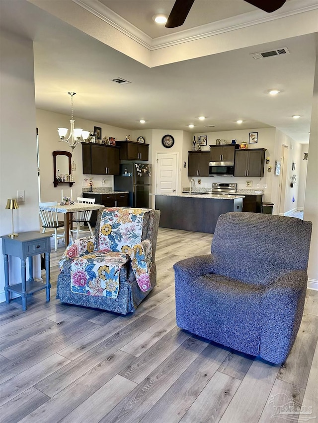 2656 Avalon St, Cantonment, FL 32533 - living area featuring visible vents, ornamental molding, and light wood-type flooring