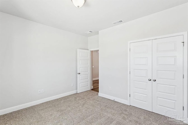 2656 Avalon St, Cantonment, FL 32533 - unfurnished bedroom featuring a closet, baseboards, carpet flooring, and visible vents