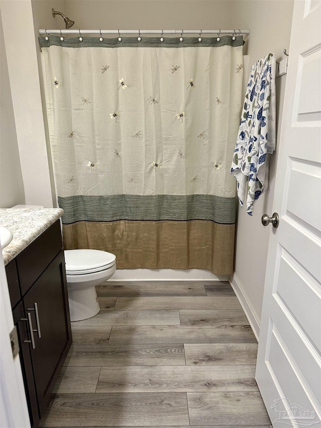 2656 Avalon St, Cantonment, FL 32533 - full bathroom featuring a shower with shower curtain, toilet, wood finished floors, and vanity