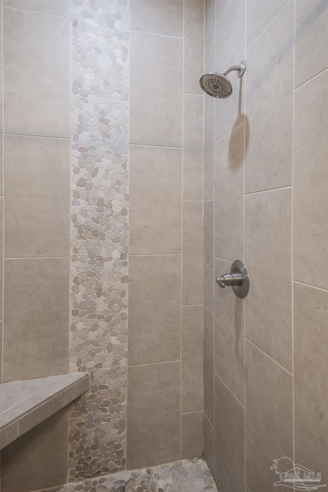 bathroom with a tile shower