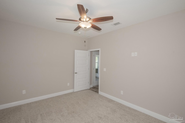 unfurnished room with light carpet, ceiling fan, visible vents, and baseboards