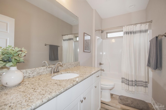 full bathroom with toilet, shower / tub combo with curtain, and vanity