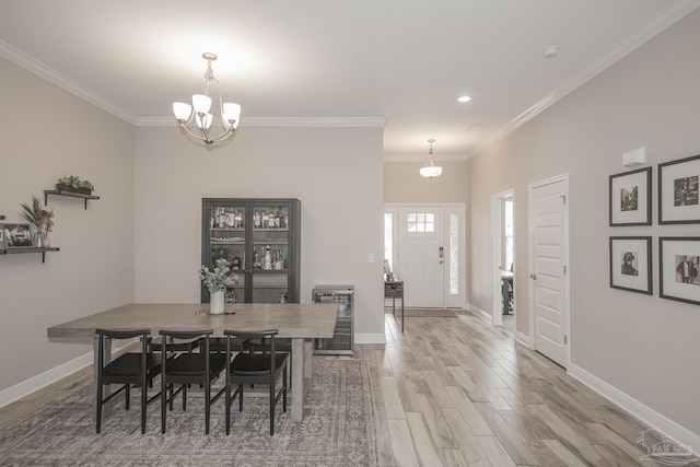 dining space with heating unit, ornamental molding, wood finished floors, and baseboards