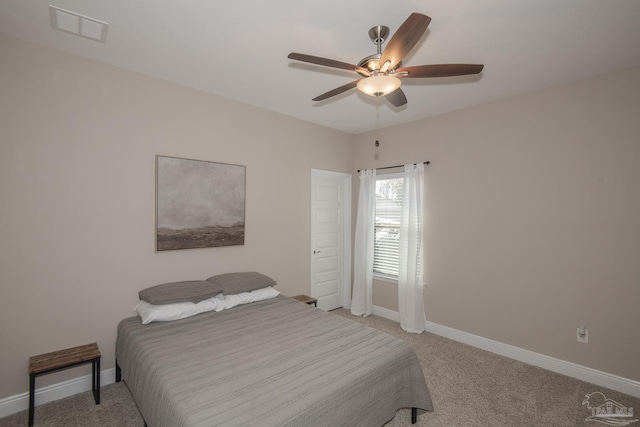 bedroom featuring a ceiling fan, light colored carpet, visible vents, and baseboards