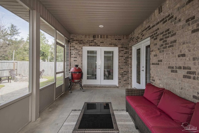 unfurnished sunroom featuring french doors