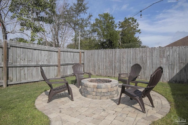 view of patio with a fenced backyard and a fire pit