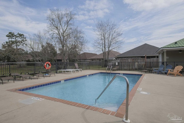 pool featuring fence and a patio