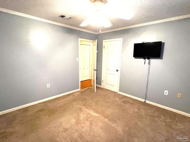 unfurnished bedroom featuring ornamental molding, a textured ceiling, carpet floors, and ceiling fan