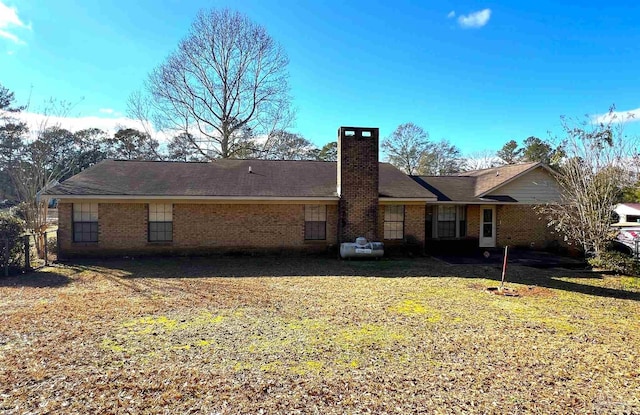 rear view of property with a lawn