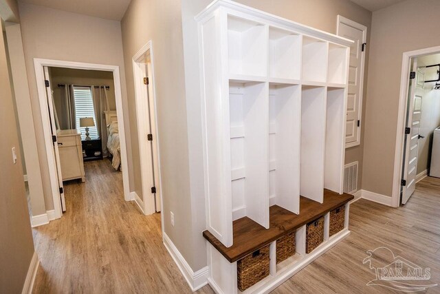 mudroom with light hardwood / wood-style floors