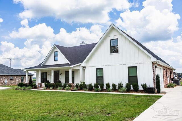 modern farmhouse style home featuring a front lawn and cooling unit