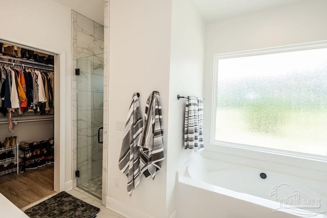 bathroom featuring separate shower and tub and hardwood / wood-style floors