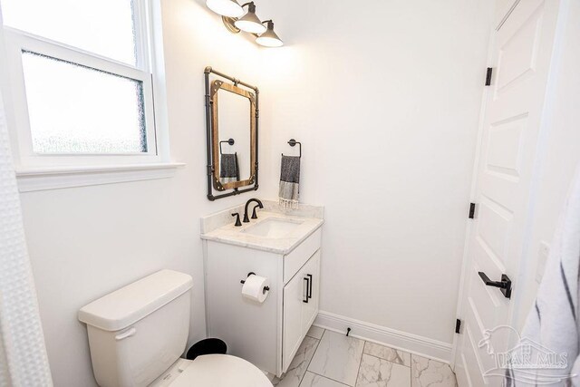 bathroom with vanity, tile patterned floors, and toilet