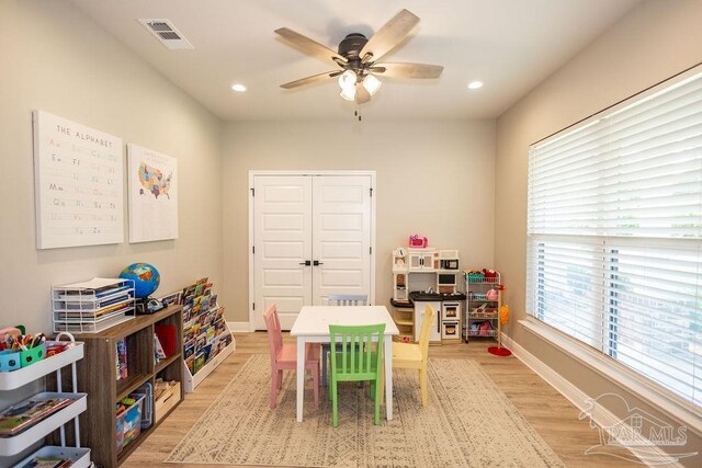 game room featuring plenty of natural light, ceiling fan, and light hardwood / wood-style floors